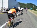 swishing by the purple-shirted mountain biker